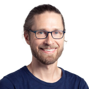 Formal headshot of faculty member Trygve Bakken against a white background.