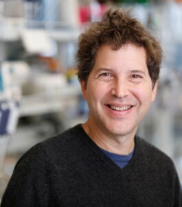 Formal headshot of faculty member David Baker in lab.