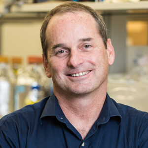 Formal headshot of faculty member John Aitchison.