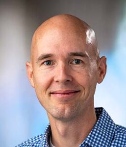 Formal headshot of faculty member Brandon Hadland.