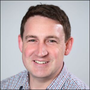 Formal headshot of faculty member Oliver Harrison.