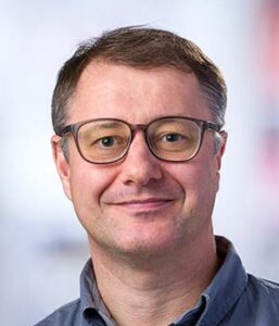 Formal headshot of faculty member Evan Newell.