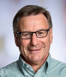 Formal headshot of faculty member Stanley Riddell.