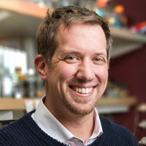 Formal headshot of faculty member David Shechner in lab.