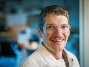 Formal headshot of faculty member Christopher Lapointe in his lab.