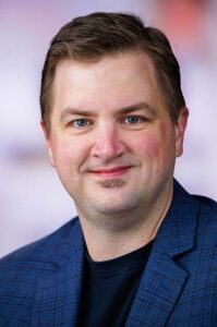 Formal headshot of faculty member Chirstopher Peterson.