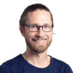 Formal headshot of faculty member Trygve Bakken against a white background.